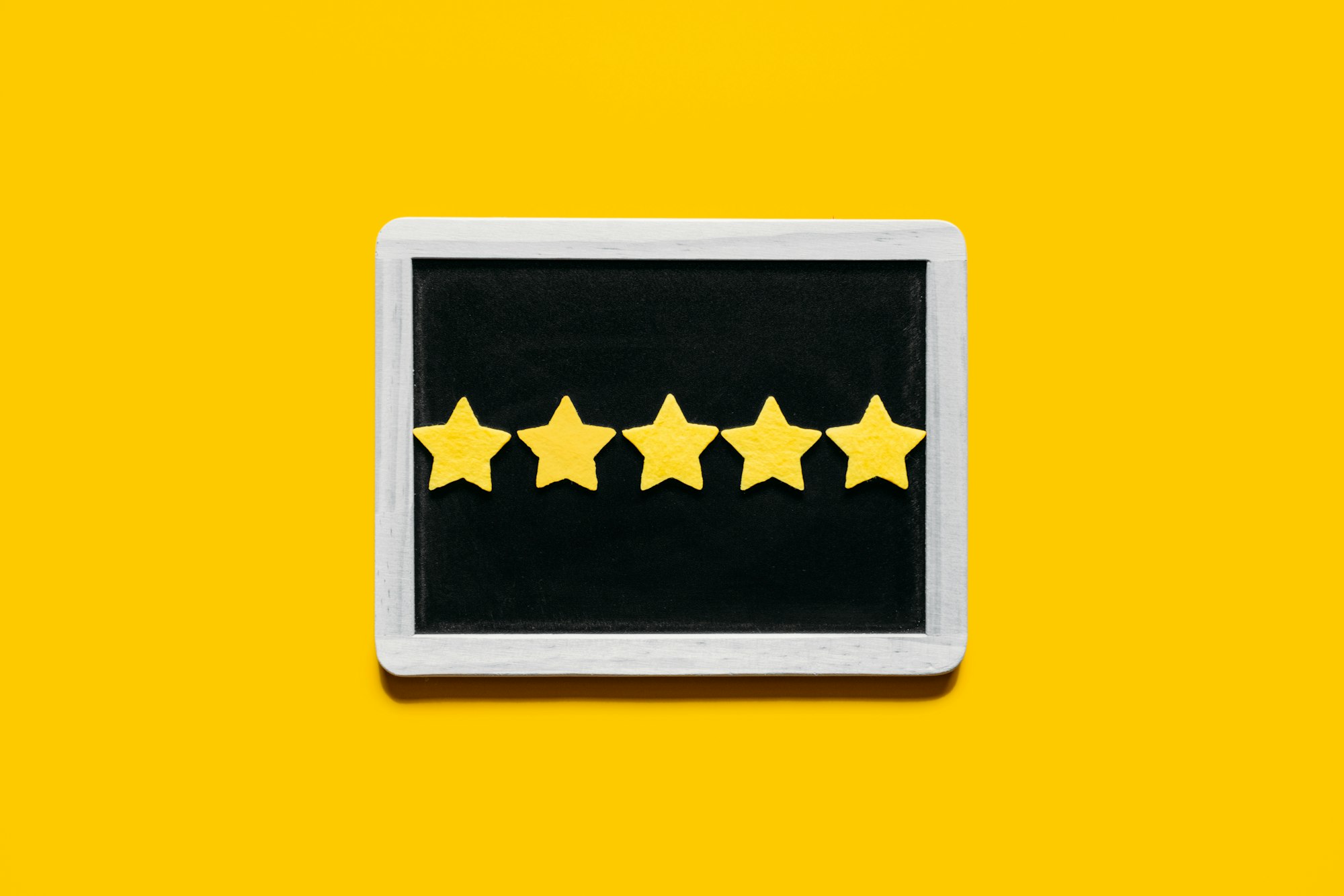 Customer Experience, Review Concept. Five yellow stars excellent rating in frame on yellow